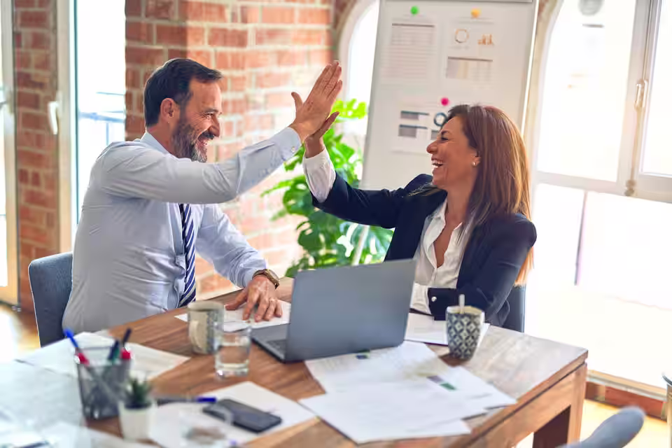 Startup founder signing business formation documents with an advisor